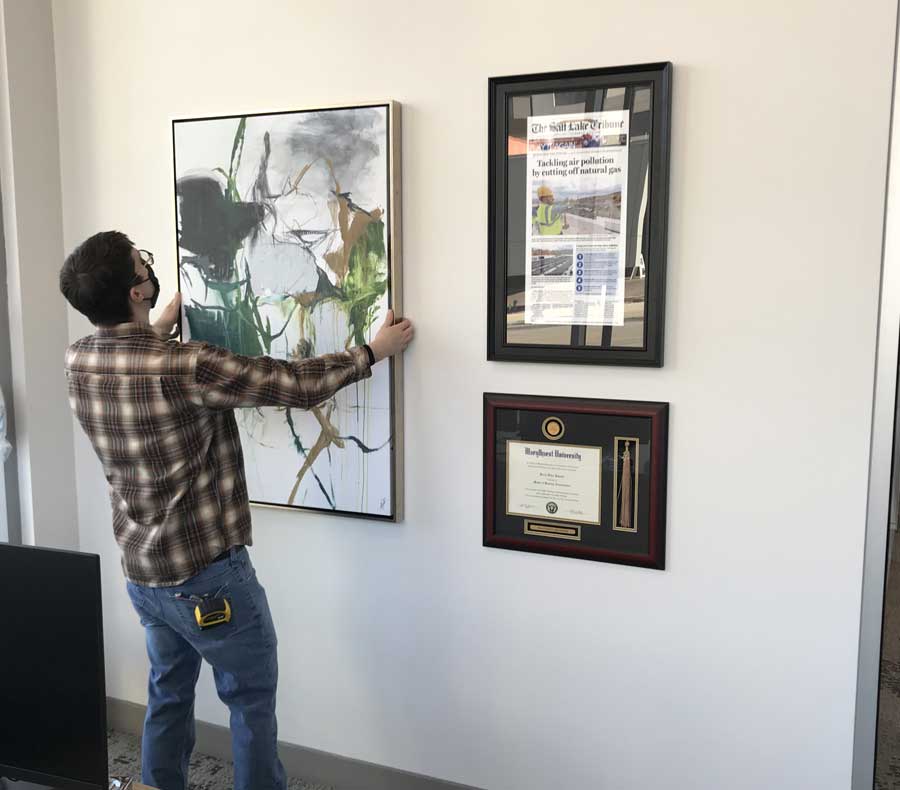 Professional picture hanging service in action